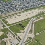 Driving piling for the new bridge south of Bridlewood and earthworks for new lanes in the median of Highway 22X (looking northeast)