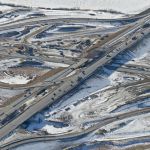 View of the interchange with eastbound and westbound traffic realigned onto the ultimate westbound lanes - allowing for the demolition and upgrade of the old portion of Highway 22X (looking southwest)
