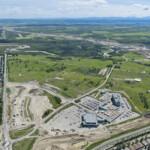 Earthworks underway for Grey Eagle Boulevard and the new roundabout connecting to 37 Street (looking southwest)