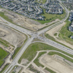 Earthworks expanding near the intersection of Highway 22X, 6 Street and Sheriff King Street, including the signalized haul truck crossing on 6 Street (looking northwest)