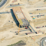 Erecting girders for the bridge at Fish Creek Boulevard (looking east)
