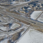 View of the bridges spanning the Canadian Pacific Railway line, as well as the intersection of Highway 22X and 6 Street / Sheriff King Street (looking northwest)