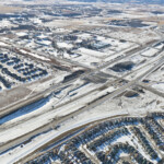 Snow covering earthworks at the intersection of Highway 22X and James McKevitt Road / Spruce Meadows Way (looking southwest)
