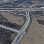 The intersection of Southland Drive and 90 Avenue is largely complete, with asphalt, curbs and drainage in place (looking southwest)